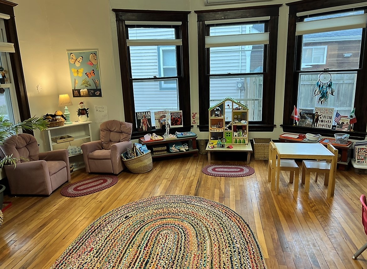 a large room with rug and table